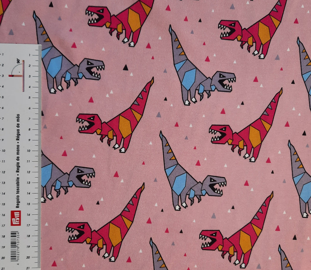 #215 dinosaures fond rose vendu au demi mètre Coton Lycra surplus